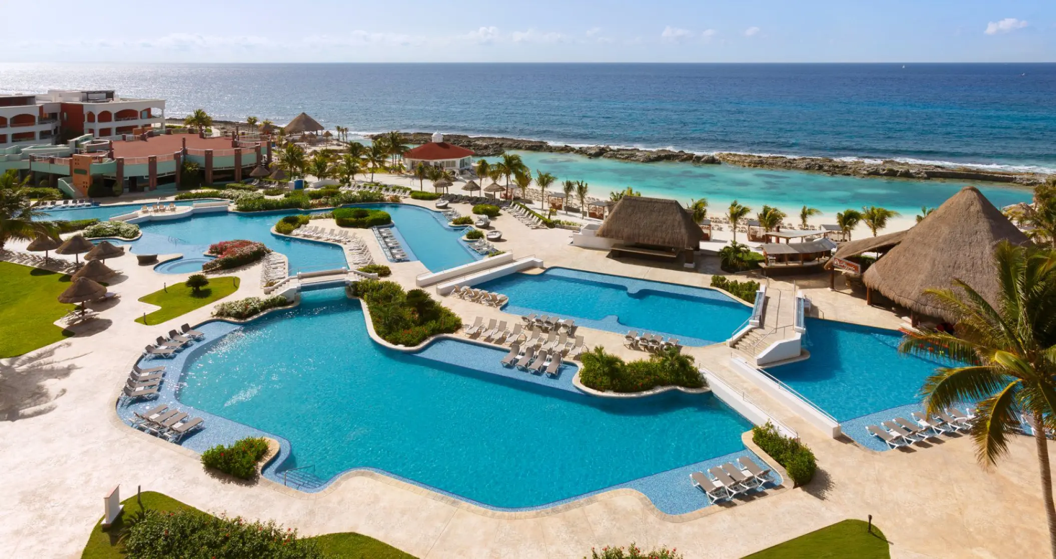Overview of the expansive pool area and beach cove at Hard Rock Riviera Maya