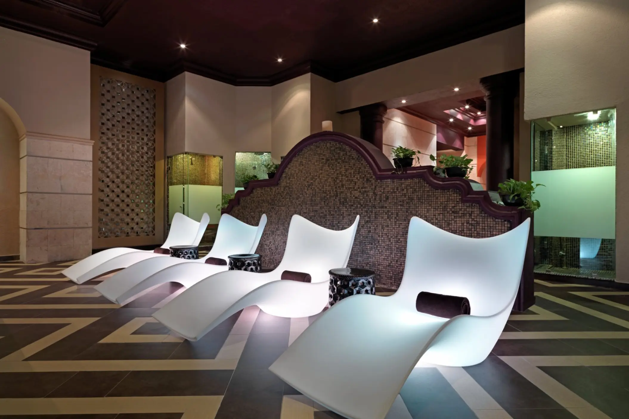 Illuminated white lounge chairs in the spa at Hard Rock Riviera Maya