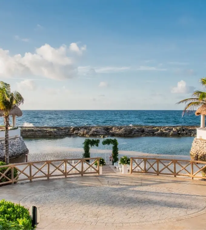 Beachfront wedding ceremony setup between two palapas at Hard Rock Riviera Maya
