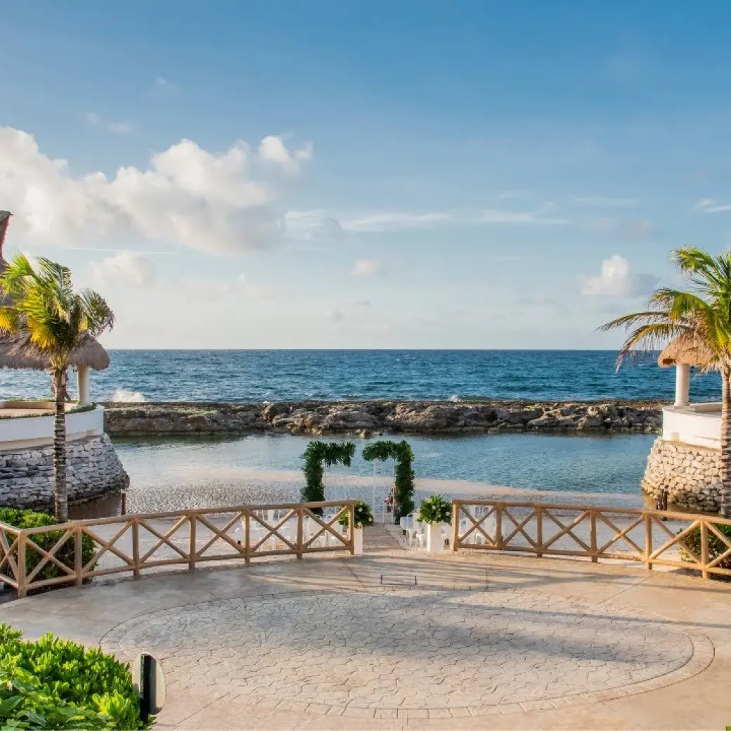 Beachfront wedding ceremony setup between two palapas at Hard Rock Riviera Maya