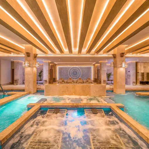 Haven Riviera Cancun indoor hydrotherapy spa pool with illuminated wood ceiling, Riviera Maya