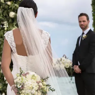 Bride and groom sharing a look during their wedding ceremony at Haven Riviera Cancun, Riviera Maya