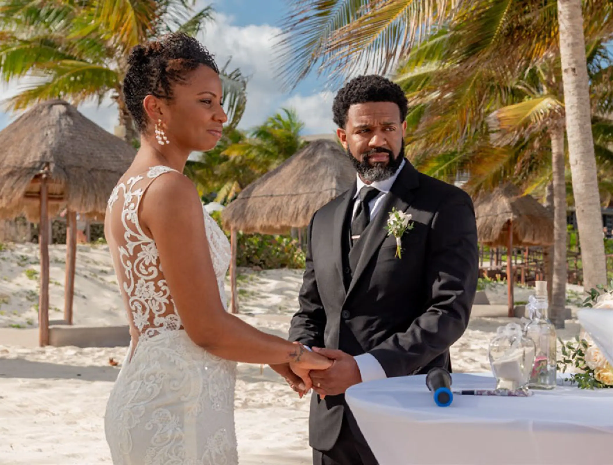Bride and groom holding hands during a beach ceremony at Haven Riviera Cancun, Riviera Maya