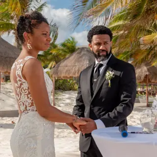 Bride and groom holding hands during a beach ceremony at Haven Riviera Cancun, Riviera Maya
