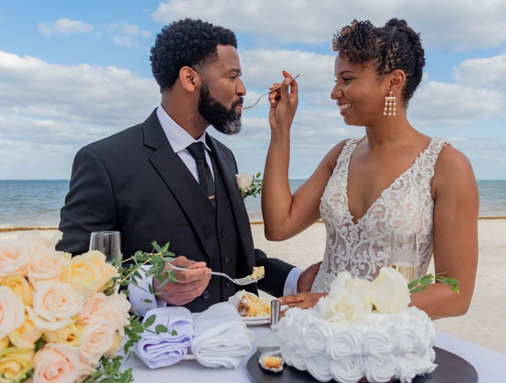 Bride and groom feeding each other cake at Haven Riviera Cancun, Riviera Maya
