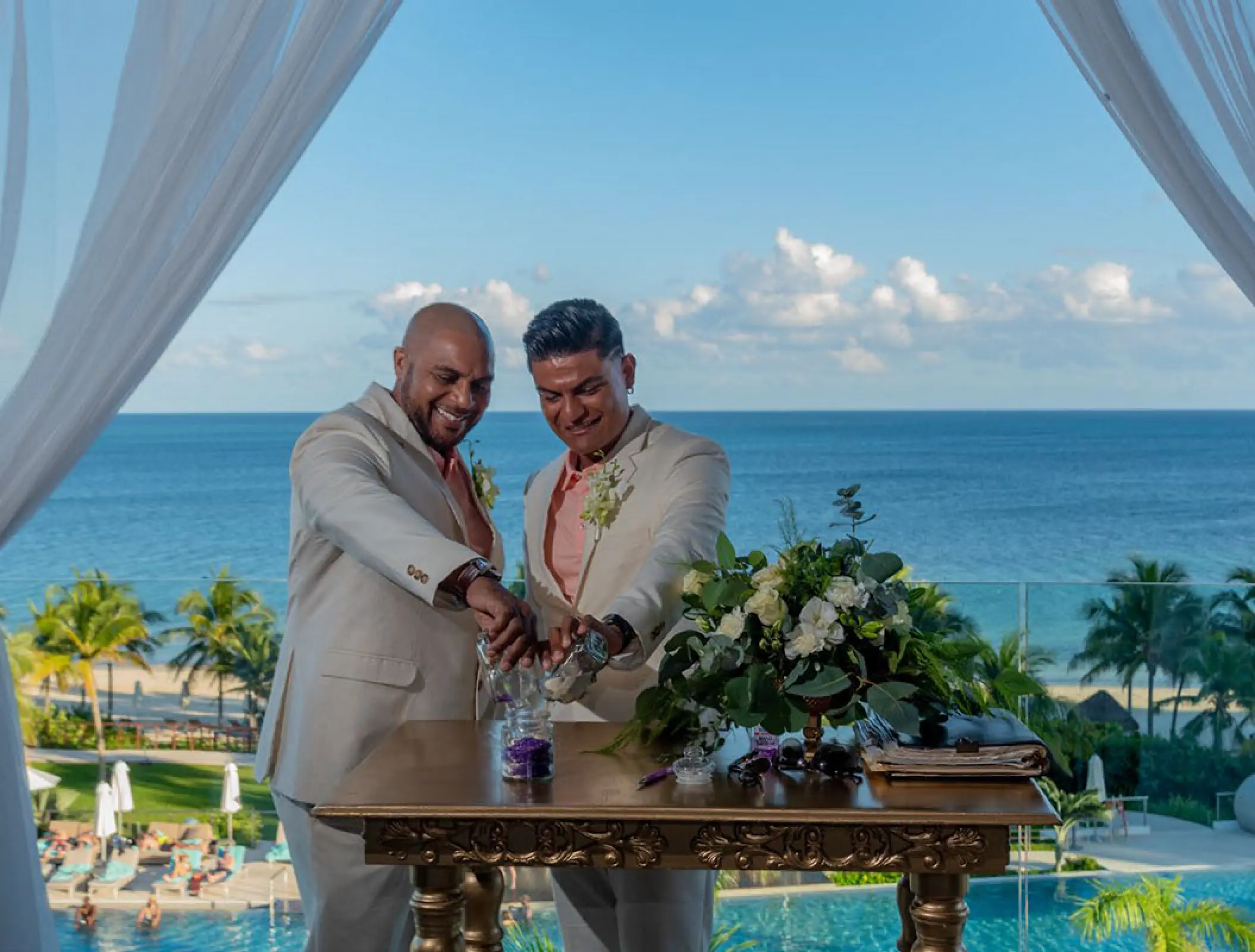Grooms performing a sand ceremony at Haven Riviera Cancun, Riviera Maya