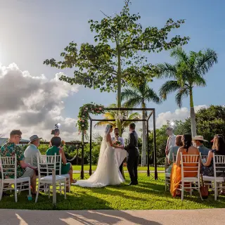Garden wedding ceremony under a floral arch at Haven Riviera Cancun, Riviera Maya