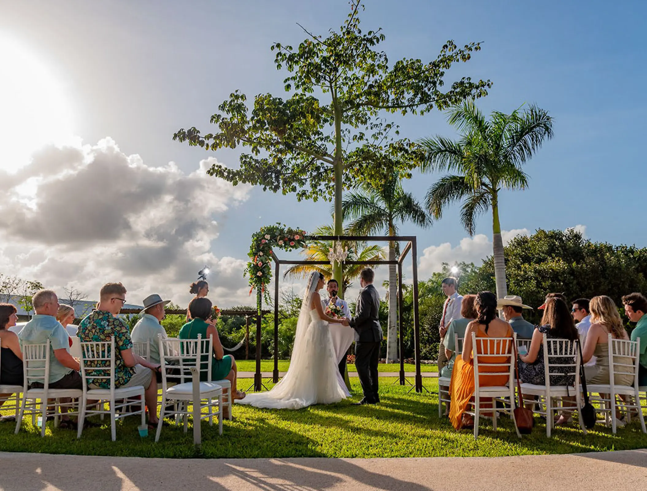 Garden wedding ceremony under a floral arch at Haven Riviera Cancun, Riviera Maya