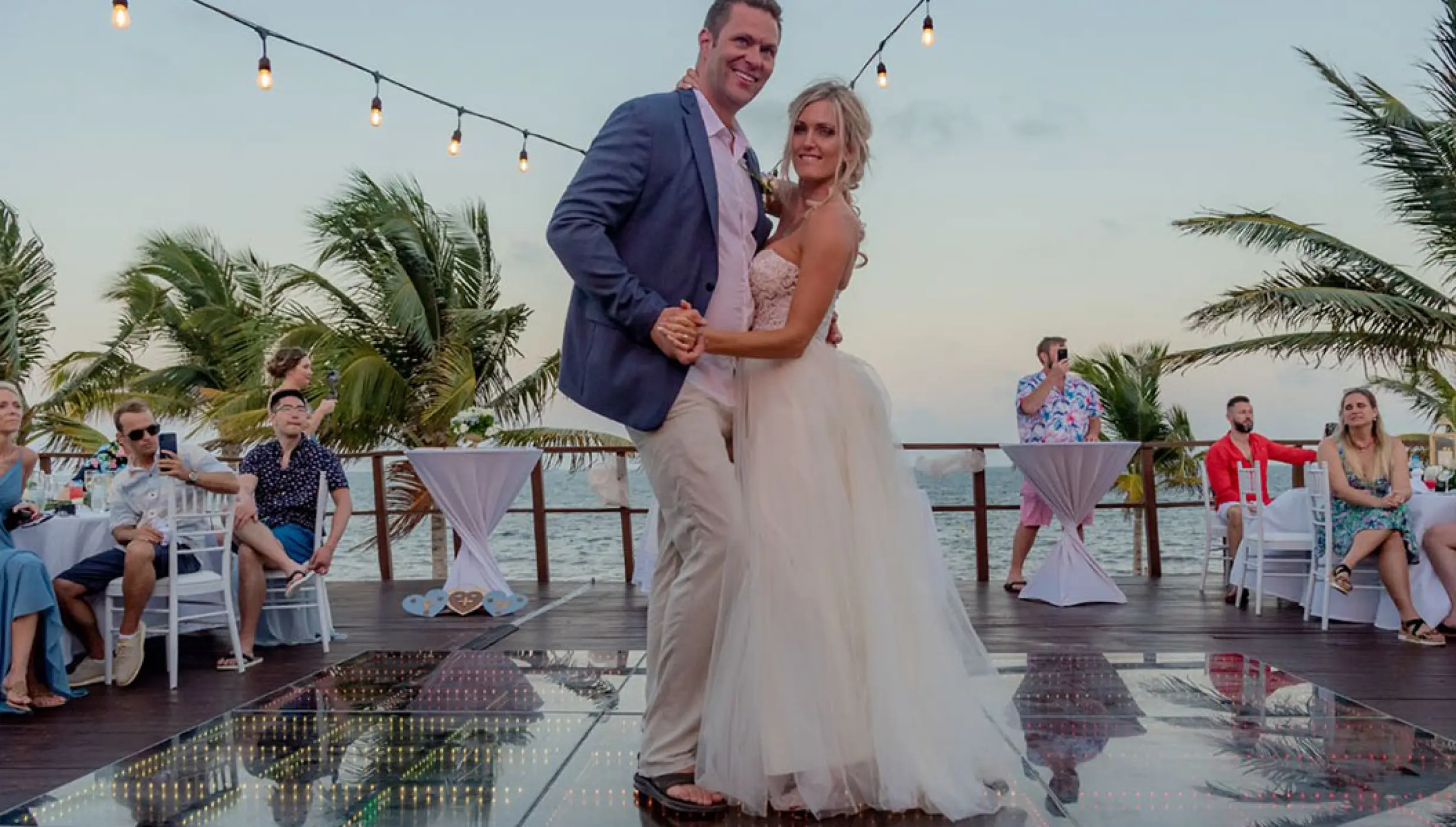 Couple's first dance at Vora Deck wedding venue at Haven Riviera Cancun Resort.