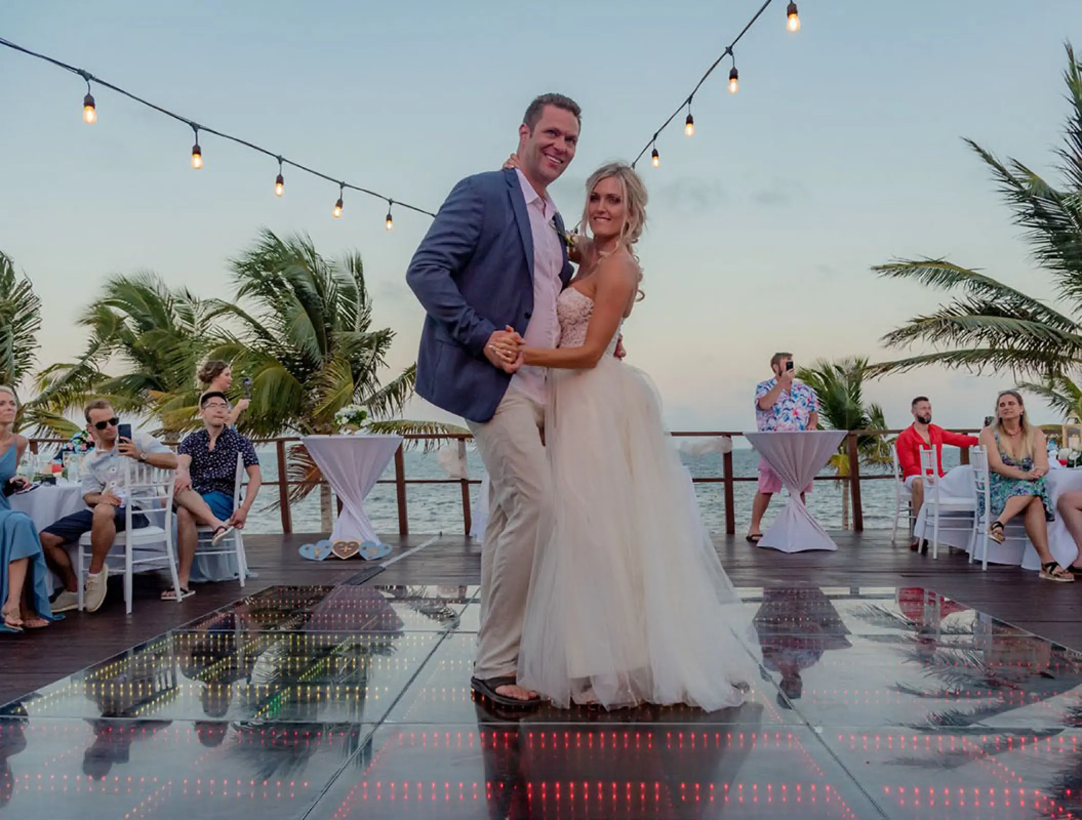 The couple dancing on a light-up dance floor during their wedding reception at Haven Riviera Cancun, Riviera Maya