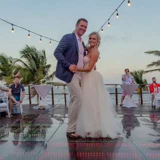 The couple dancing on a light-up dance floor during their wedding reception at Haven Riviera Cancun, Riviera Maya