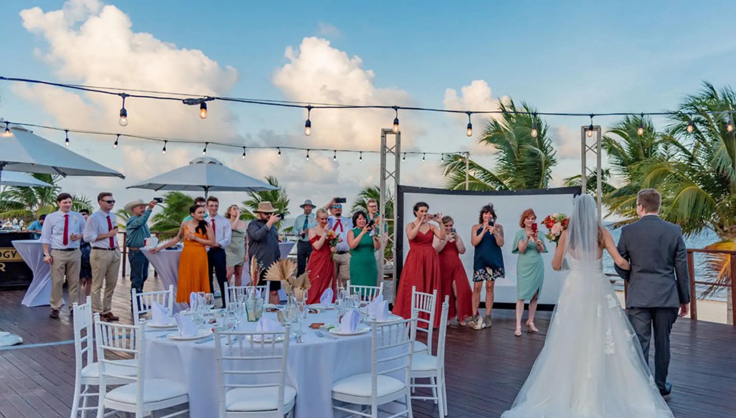 Couple's grand entrance at Vora Deck wedding venue at Haven Riviera Cancun Resort.