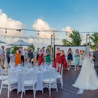 Bride and groom entering their outdoor wedding reception on Vora Deck at Haven Riviera Cancun
