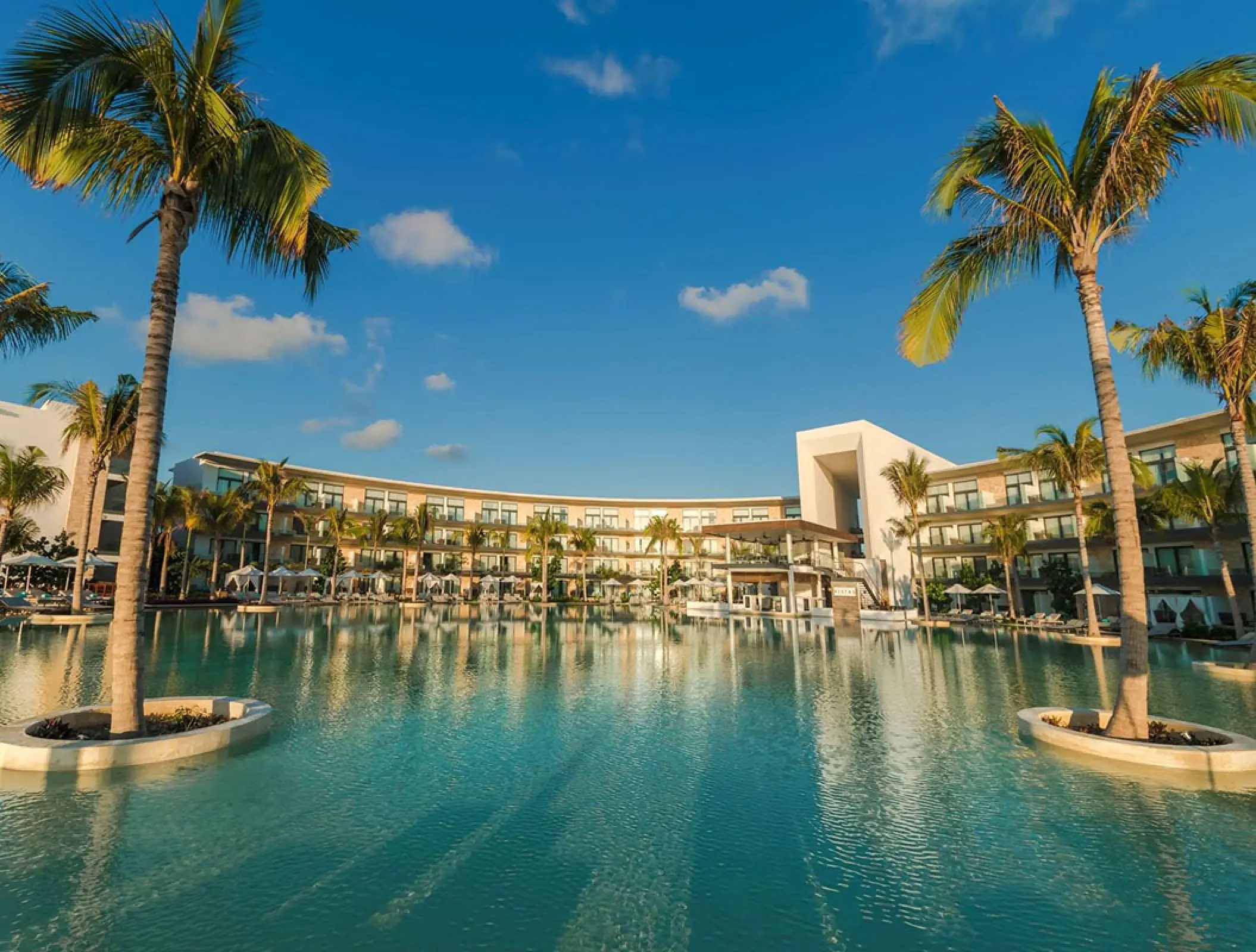 Expansive outdoor pool area and palm trees at Haven Riviera Cancun, Riviera Maya