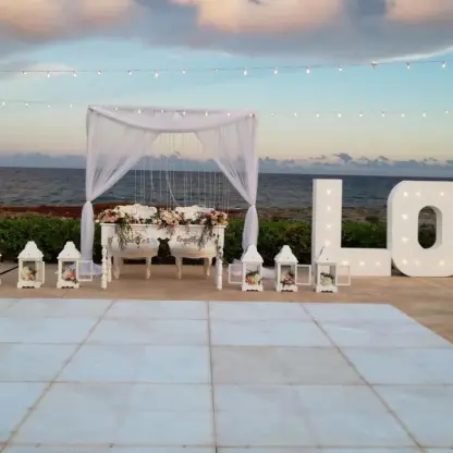 Sweetheart table and marquee LOVE letters on the Starlight Terrace at Hard Rock Riviera Maya
