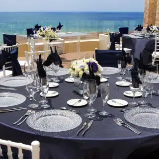 Outdoor wedding reception with navy linens and ocean views at Royalton Riviera Cancun
