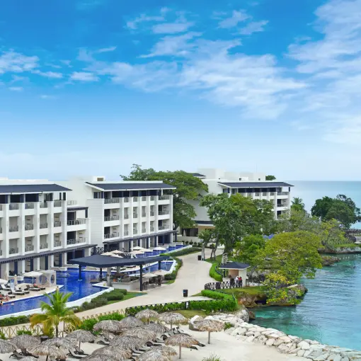Aerial view of Royalton Hideaway Negril oceanfront buildings and swim-up pools along the coast, Negril