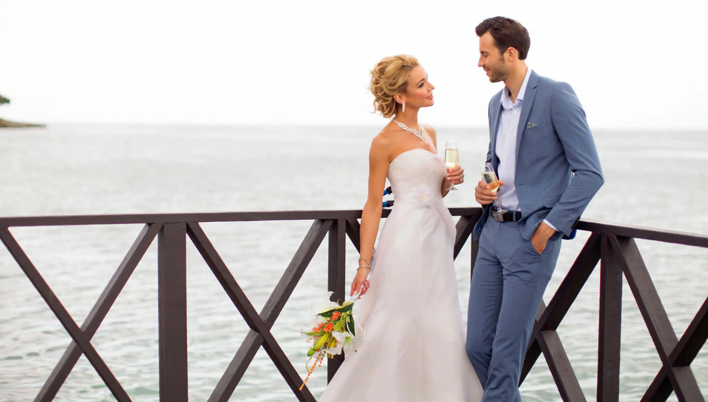 Couple in the charmin ocean pier at Hideaway at Royalton Negril