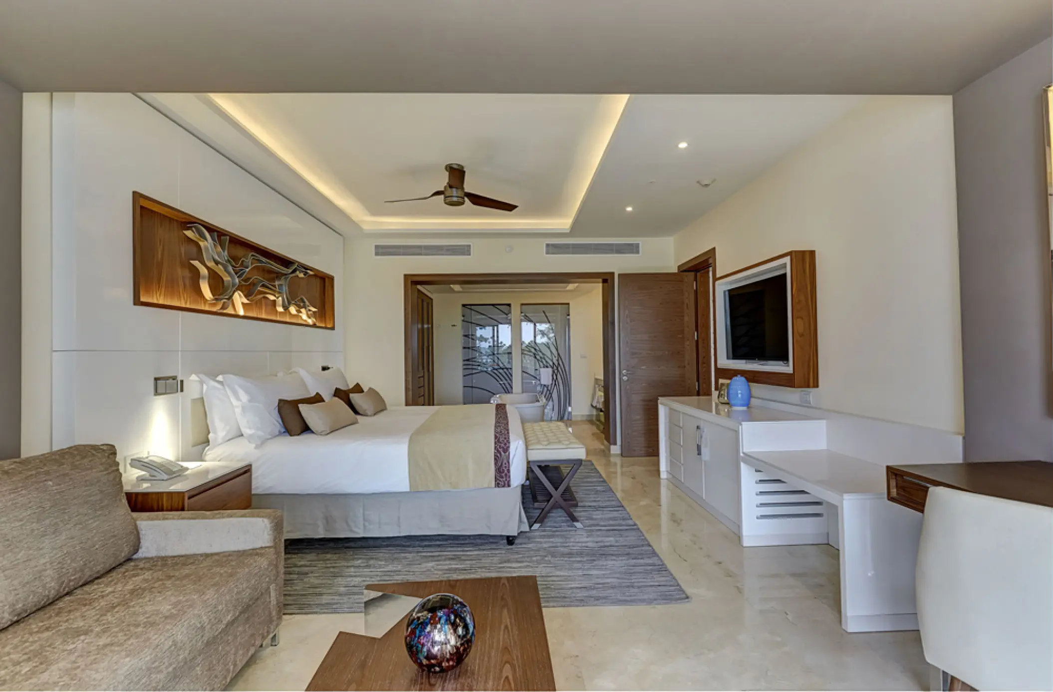 Diamond Club suite with a king bed and modern lounge area at Royalton Hideaway Negril