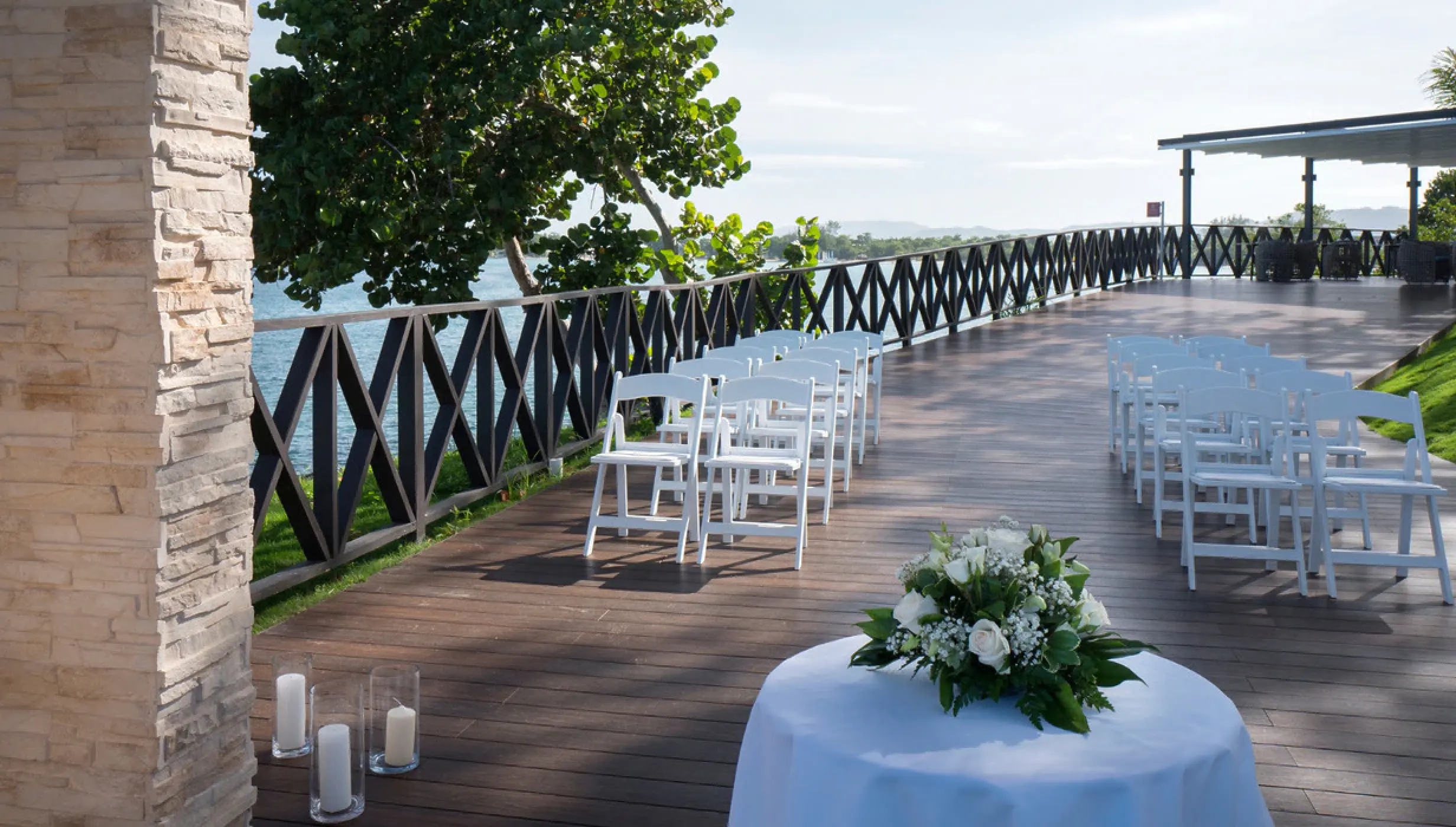Oceanfront wedding ceremony terrace with white folding chairs at Royalton Hideaway Negril, Negril
