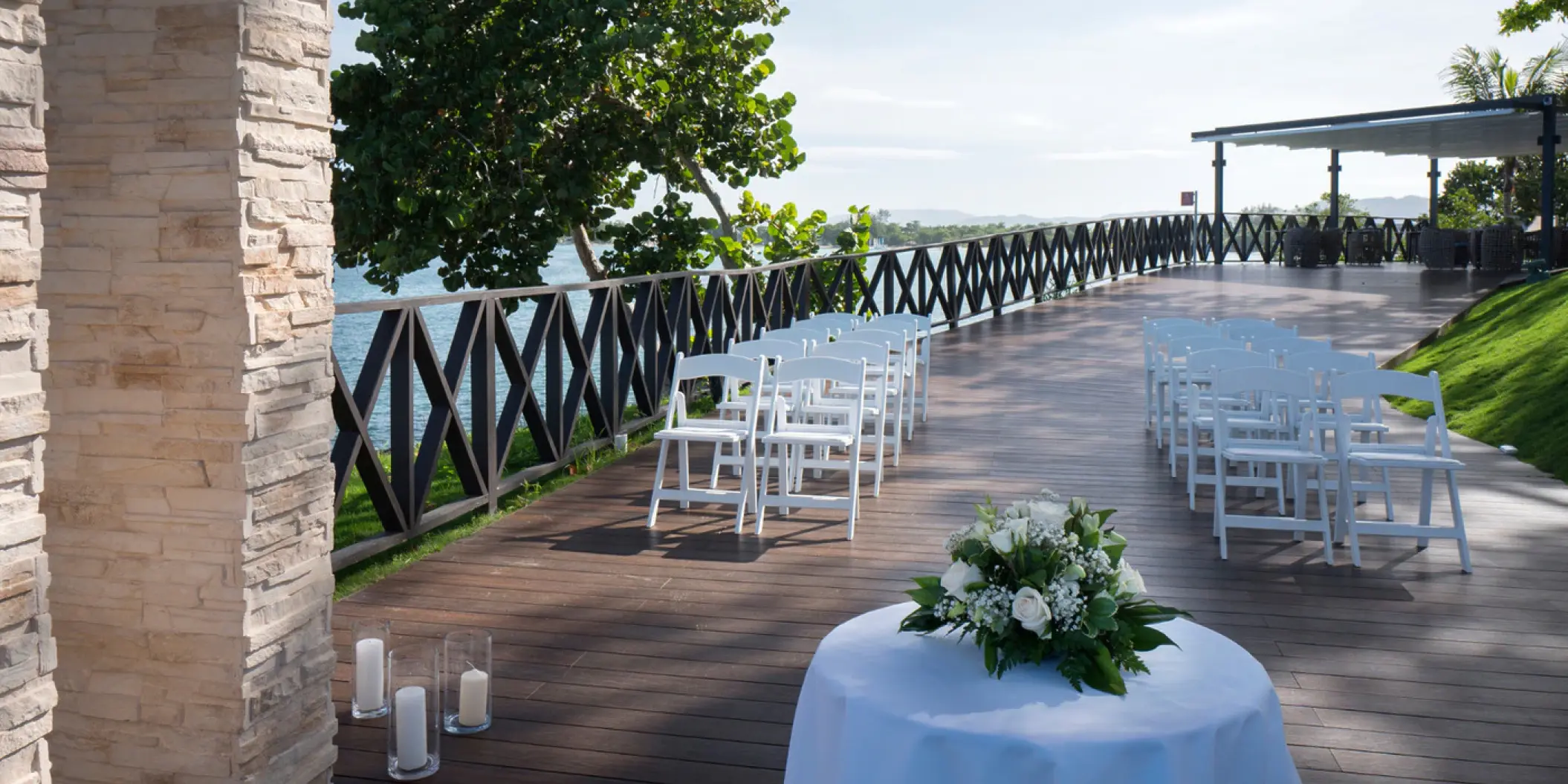Oceanfront wedding ceremony terrace with white folding chairs at Royalton Hideaway Negril, Negril