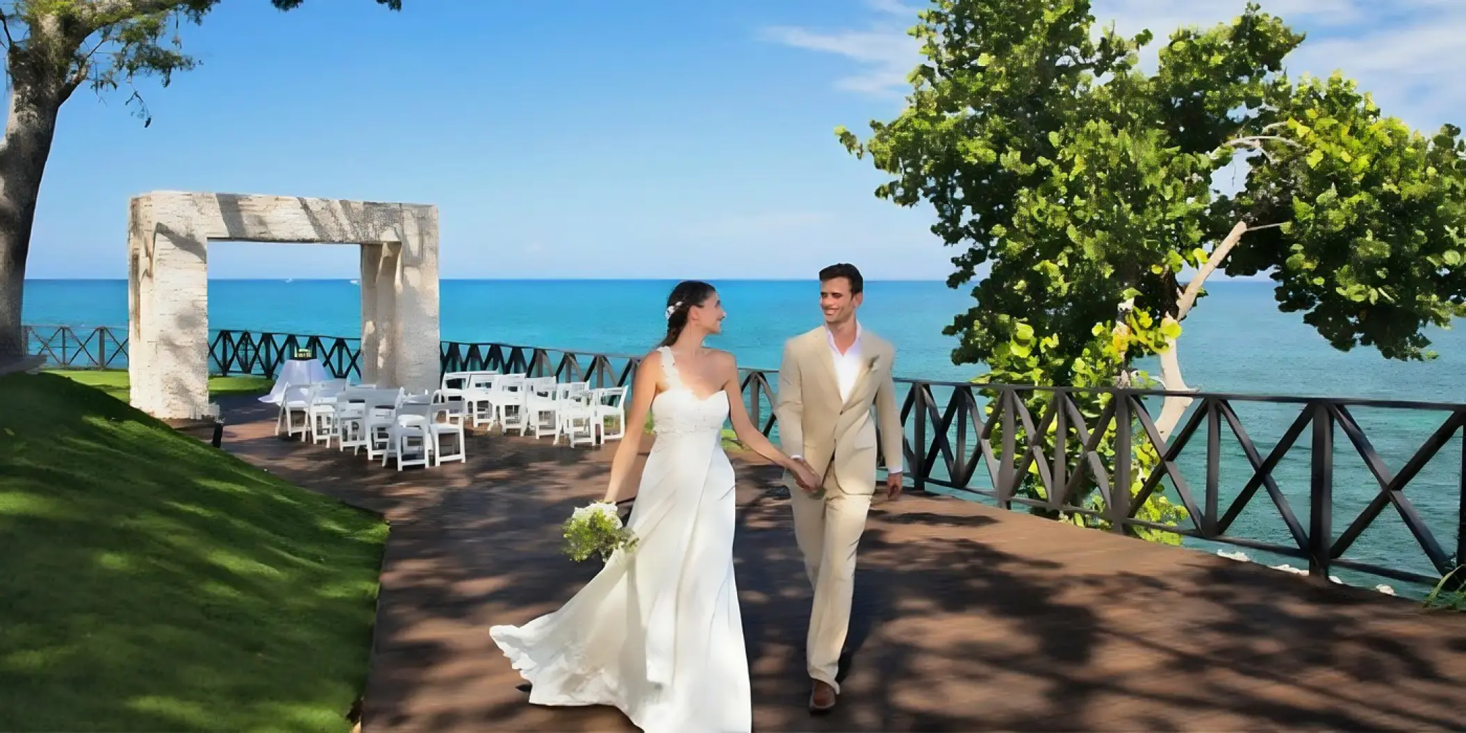 The bride and groom walking on Ocean Point terrace after their wedding ceremony at Royalton Hideaway Negril