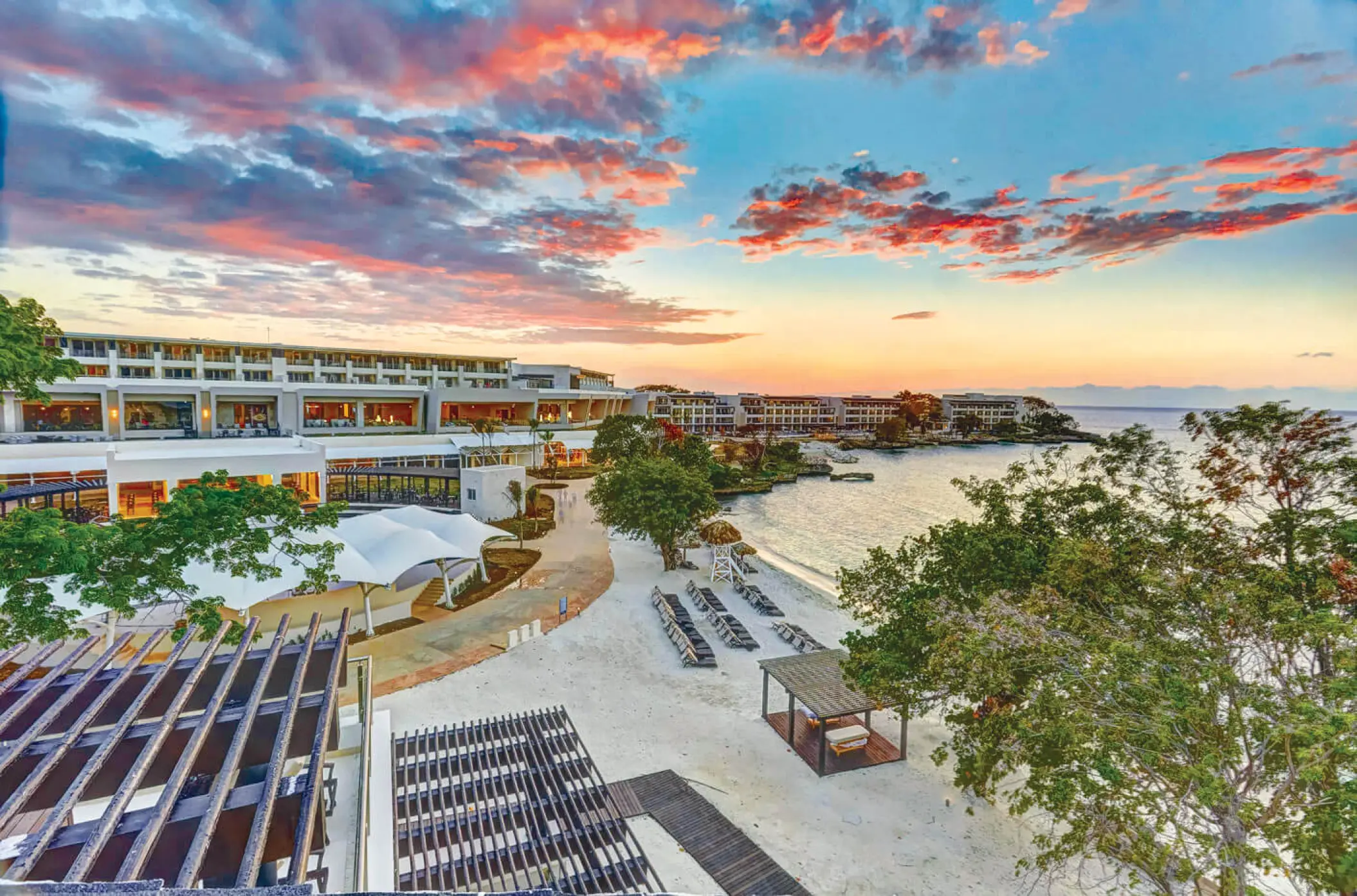Royalton Hideaway Negril overview showing beach and resort grounds under a sunset sky, Negril