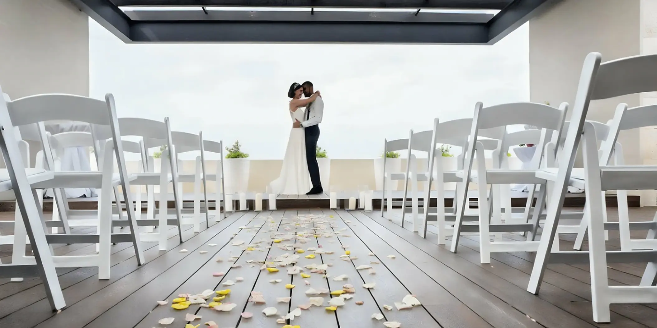 The bride and groom embracing on the sky terrace at Royalton Hideaway Negril, Jamaica