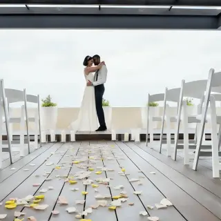 The bride and groom embracing on the sky terrace at Royalton Hideaway Negril, Jamaica