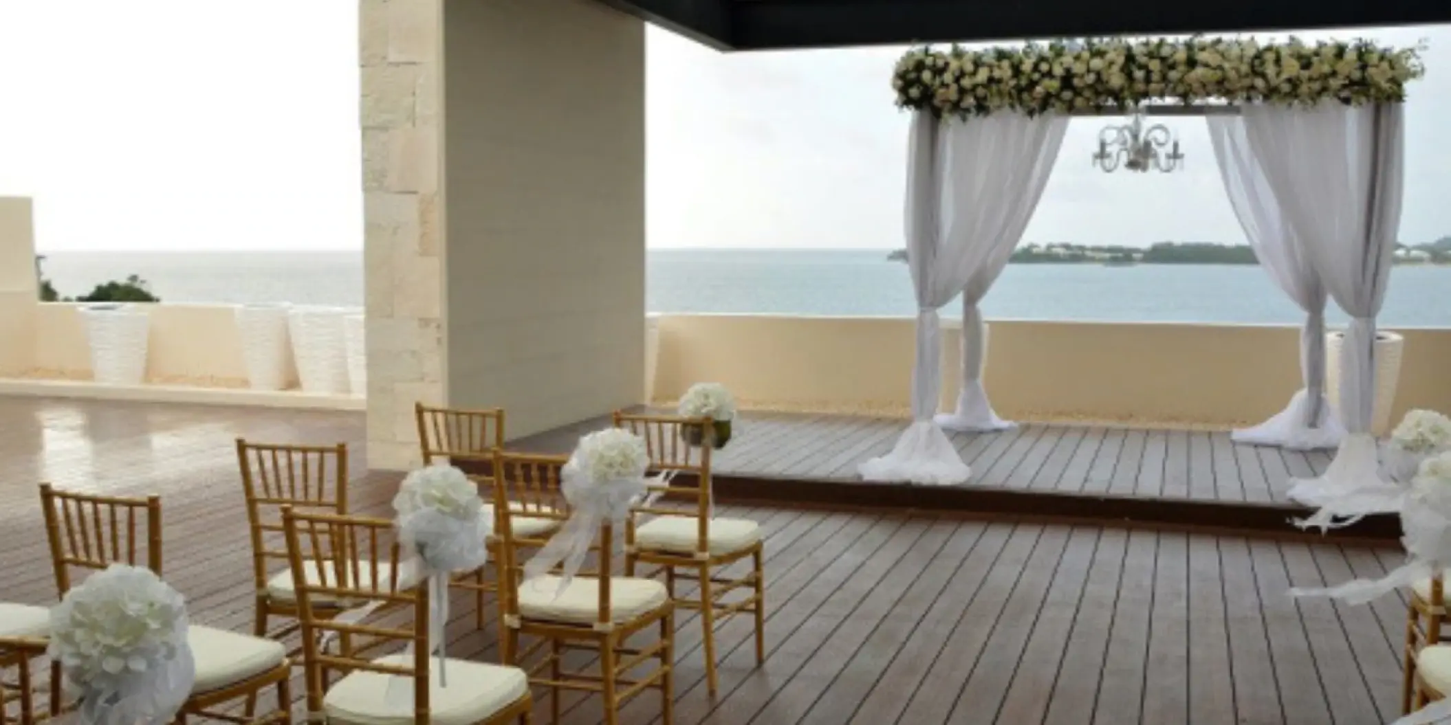 Sky terrace wedding ceremony setup with white floral arch at Royalton Hideaway Negril, Negril