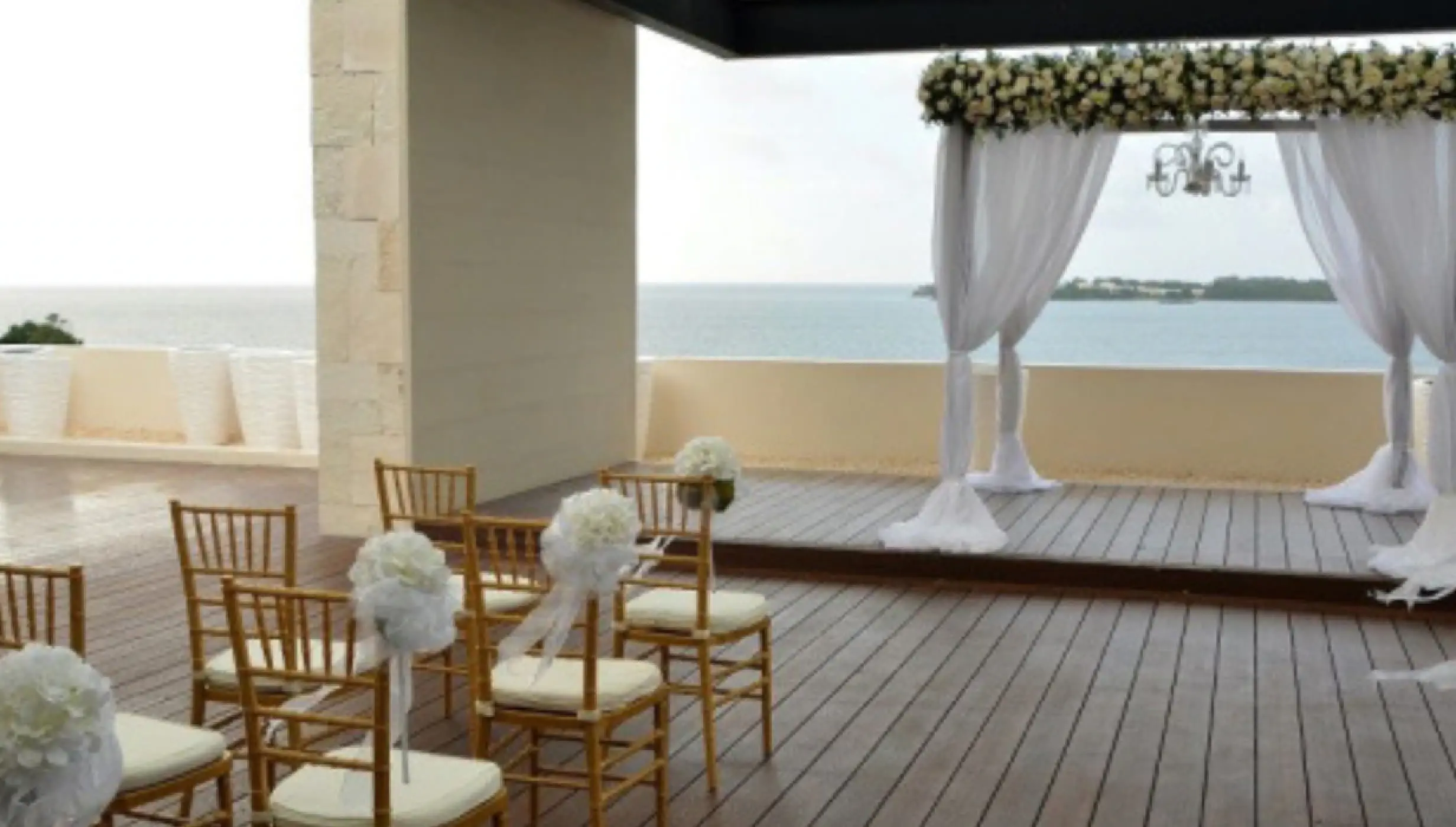 Sky terrace wedding ceremony setup with white floral arch at Royalton Hideaway Negril, Negril