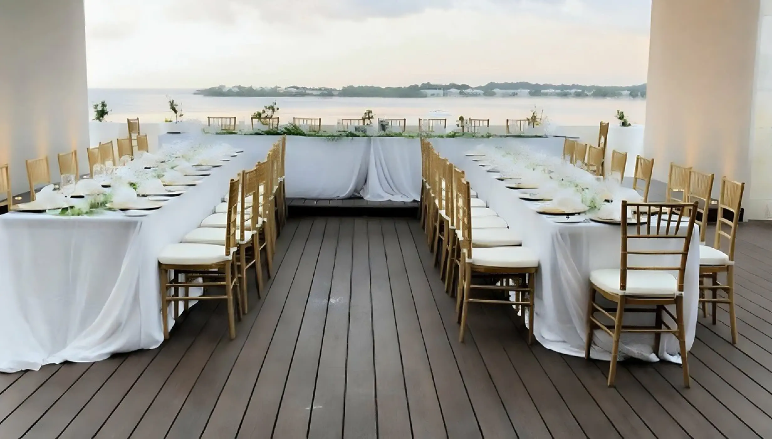 Sky terrace wedding reception with long tables and gold chairs at Royalton Hideaway Negril