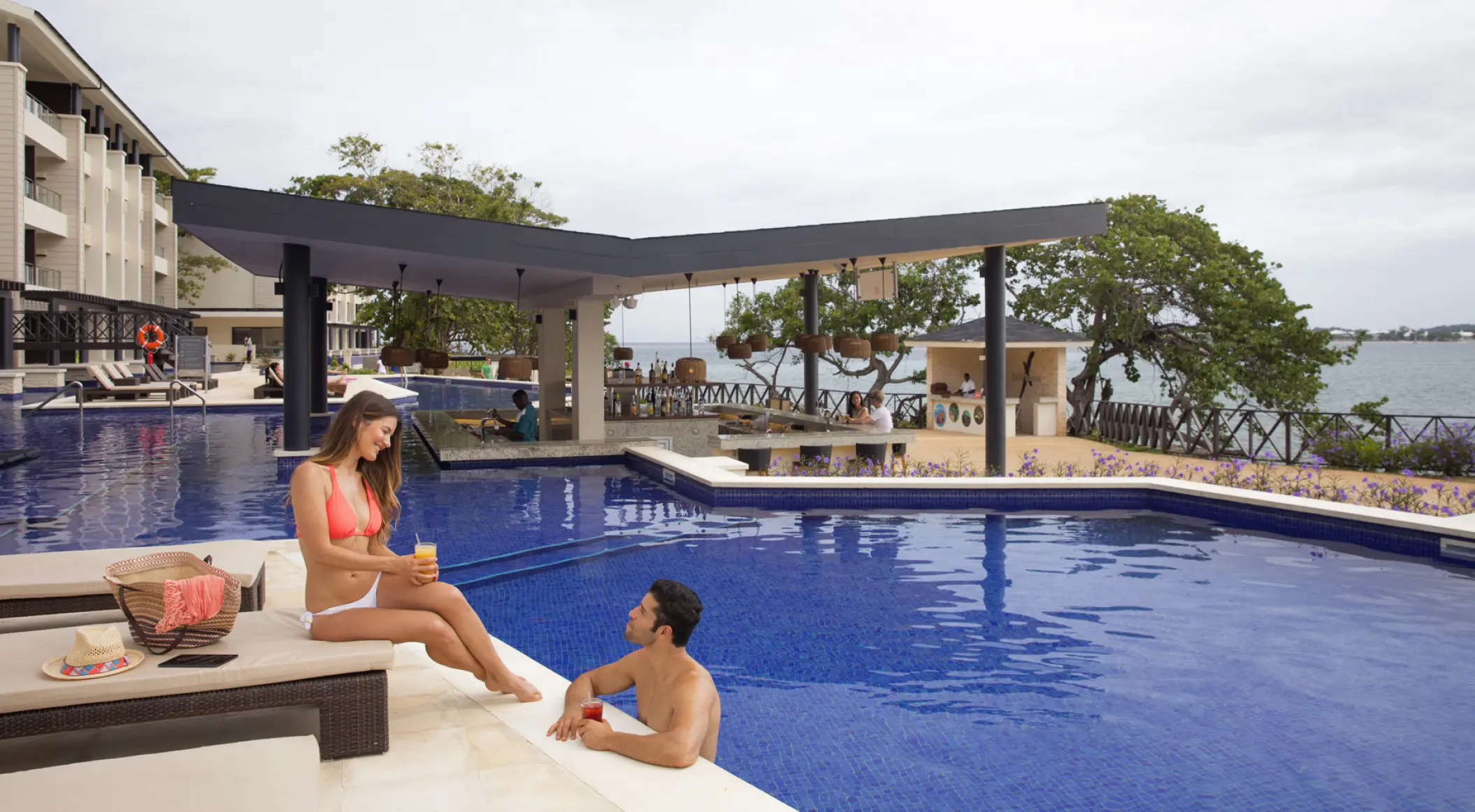 Couple relaxing by the swim-up bar pool at Royalton Hideaway Negril