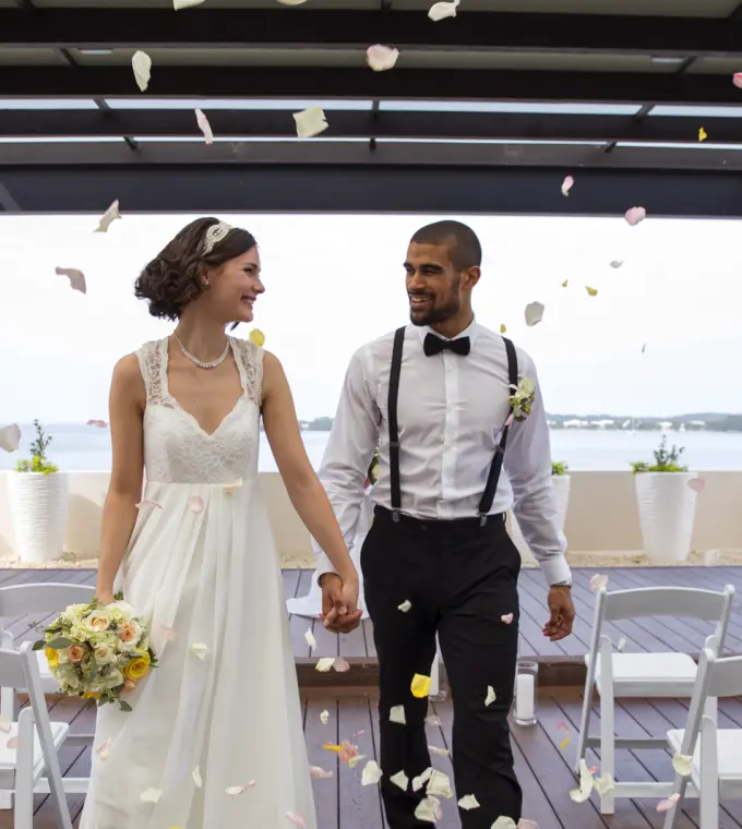 Bride and groom walking through flower petals at a Royalton Negril wedding, Negril