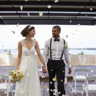Bride and groom walking through flower petals at a Royalton Negril wedding, Negril