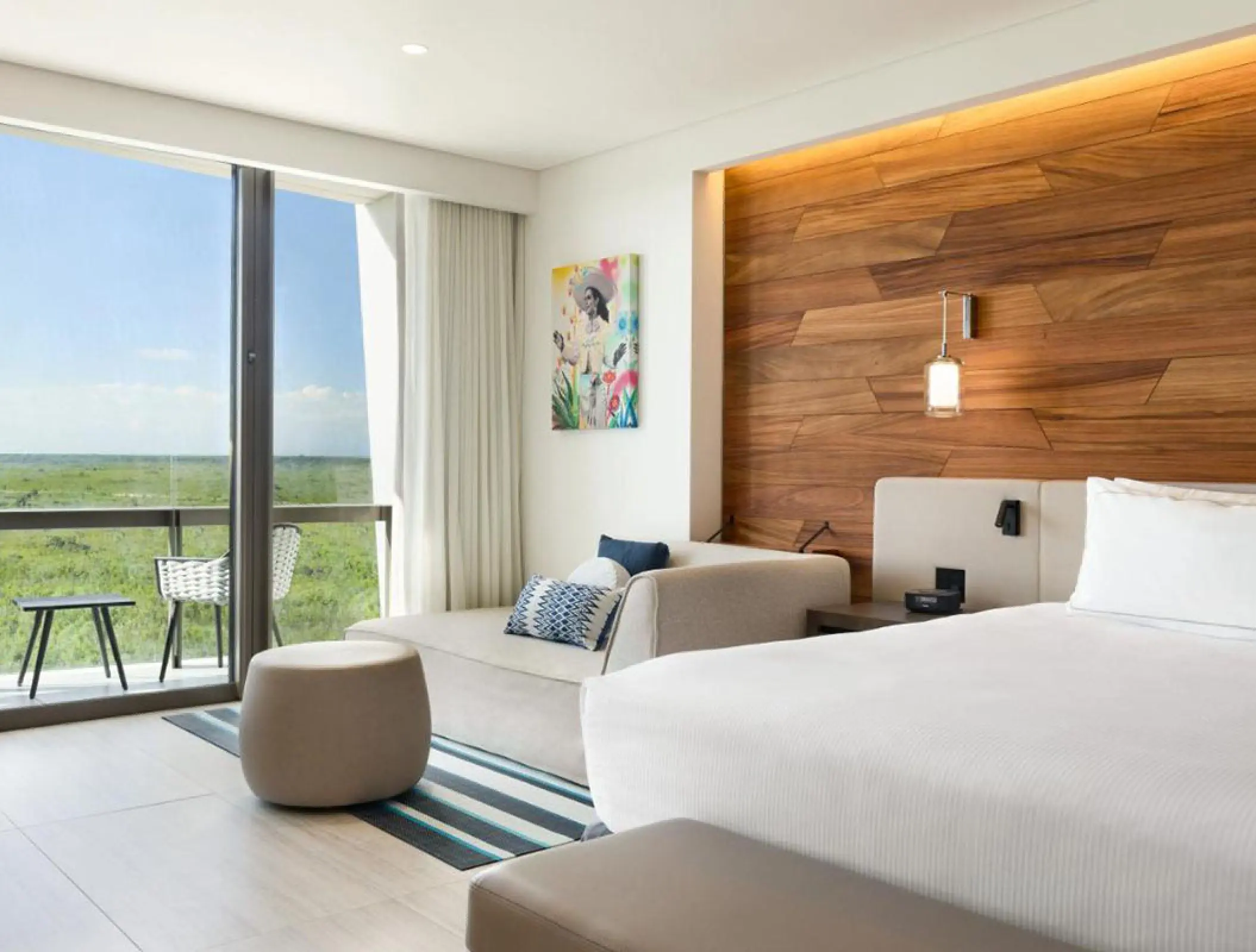 Jungle view guest room with wood paneling and balcony at Hilton Cancun, Cancun