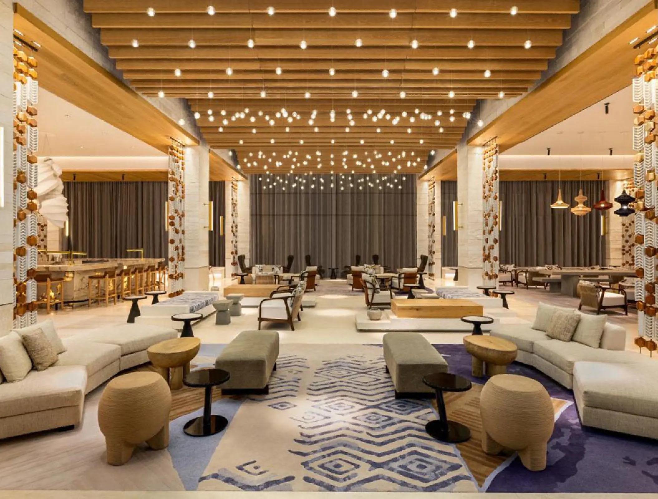 Modern lobby lounge with wood ceilings and string lighting at Hilton Cancun, Cancun