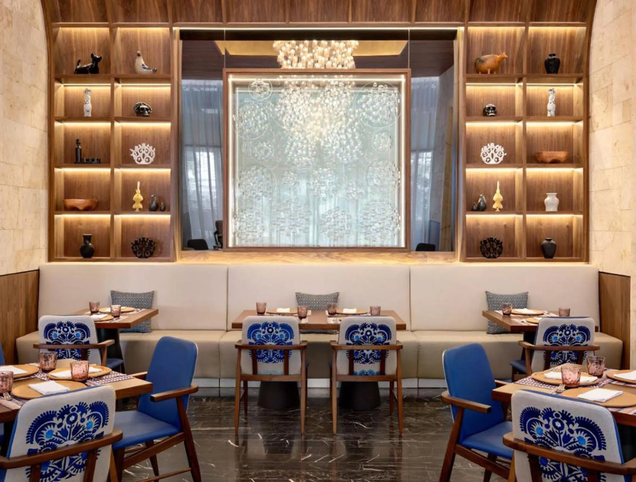 Modern restaurant dining area with blue patterned chairs at Hilton Cancun
