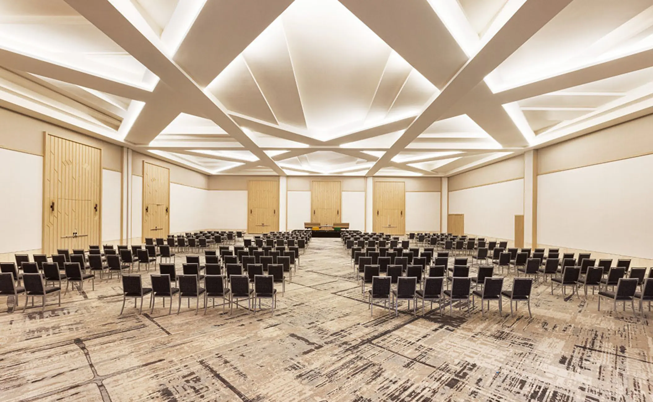 Modern wedding reception ballroom with geometric ceiling lighting at Hilton Cancun, Cancun