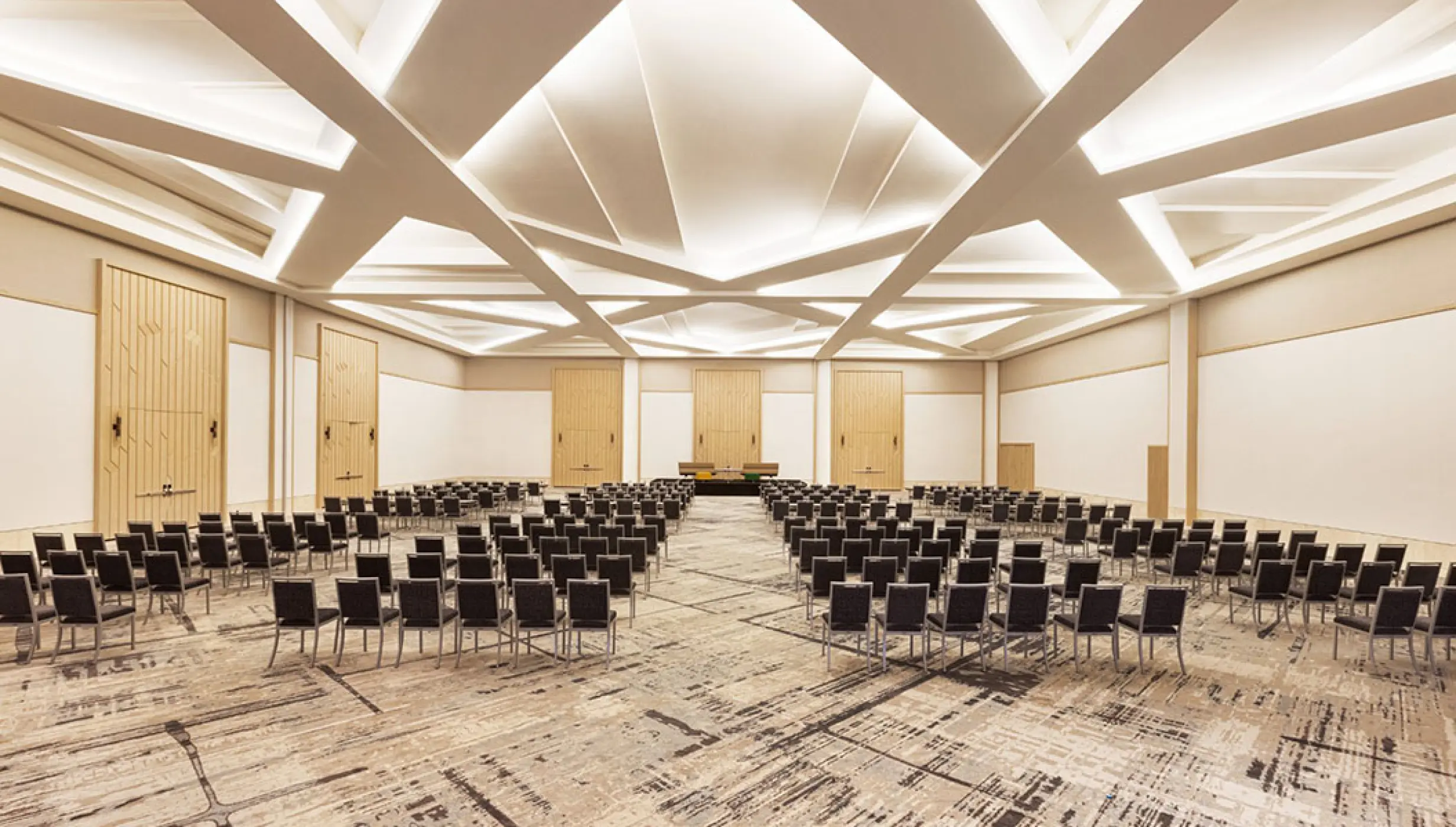 Modern wedding reception ballroom with geometric ceiling lighting at Hilton Cancun, Cancun