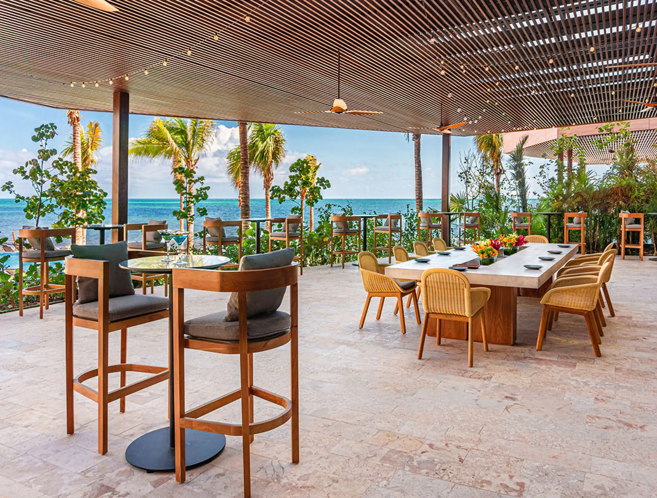 Outdoor restaurant terrace with ocean views and wooden slat ceiling at Hilton Cancun, Cancun
