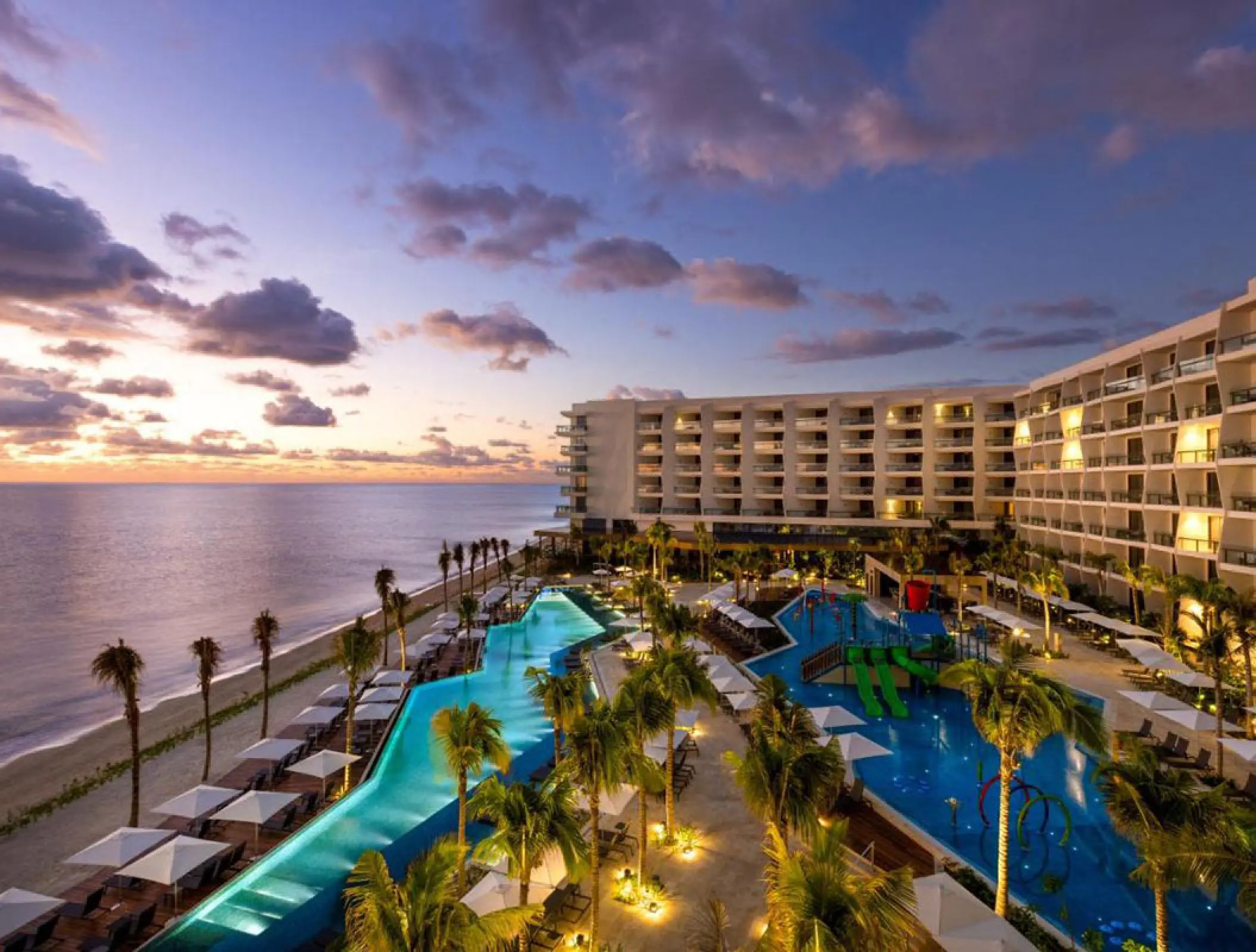 Hilton Cancun pool area and beachfront buildings at sunset, Cancun
