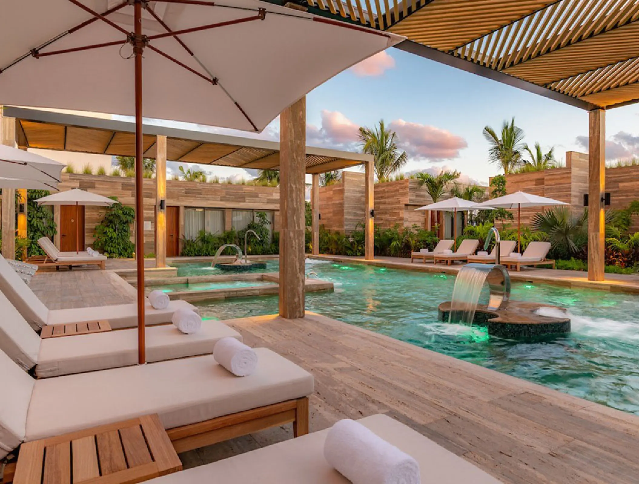 Spa hydrotherapy pool with fountains and loungers at Hilton Cancun, Cancun