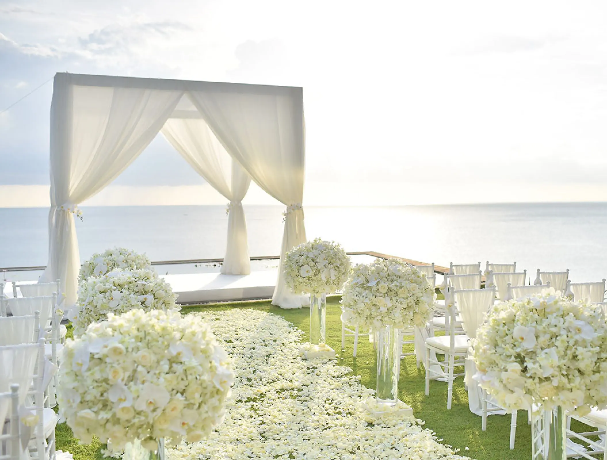 White drape wedding ceremony huppah overlooking the ocean at Hilton Cancun, Cancun