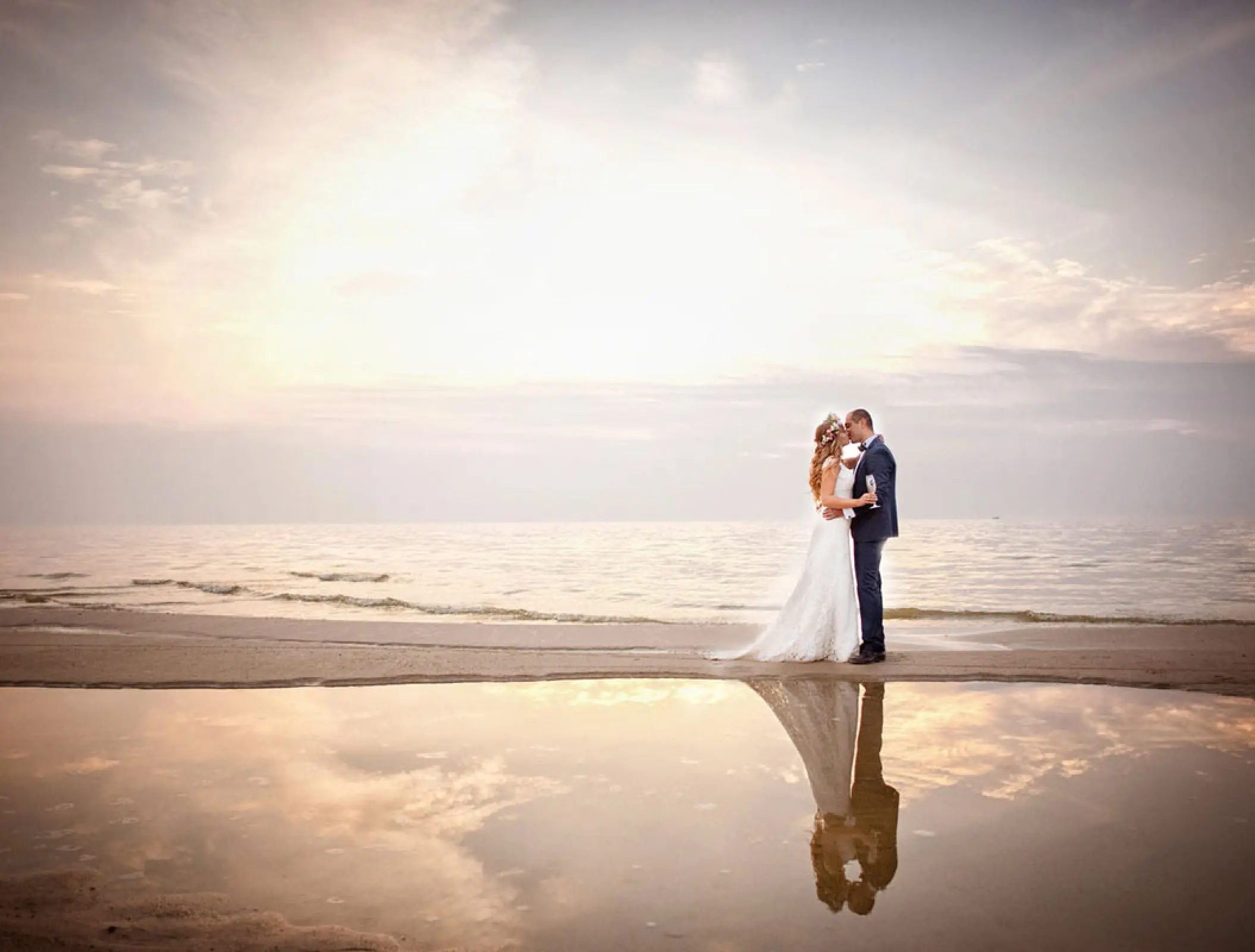 Bride and groom embracing on the beach at Hilton Cancun, Cancun