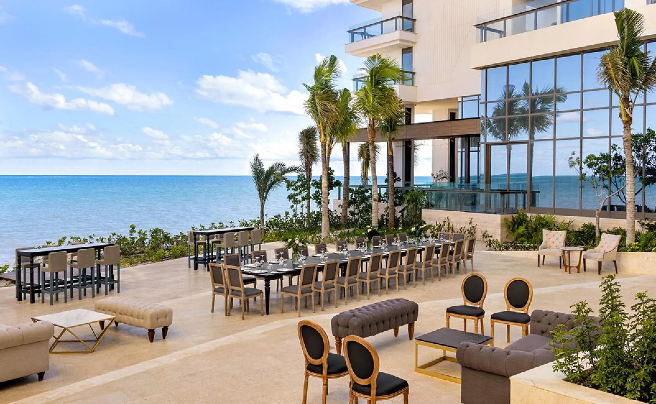 Outdoor wedding reception setup on a terrace with ocean views at Hilton Cancun, Cancun