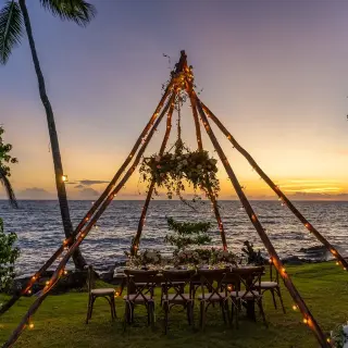 Private beach wedding reception under a wooden teepee at sunset, Secrets La Romana