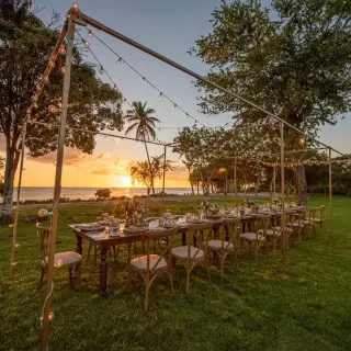 Outdoor wedding reception at Secrets La Romana, La Romana with string lights and sunset views