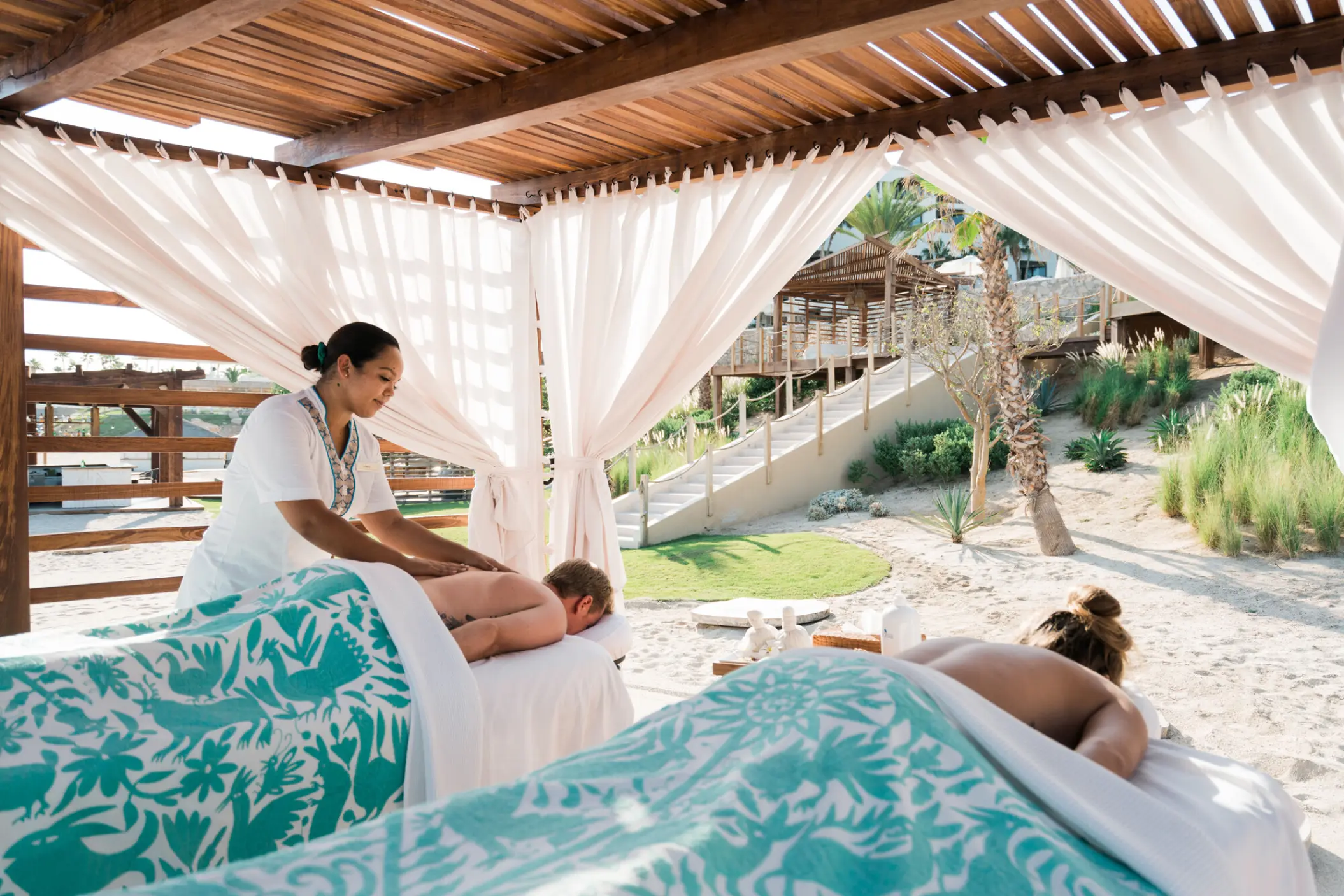 Outdoor couples massage in a beach cabana at Hilton Los Cabos, Cabo San Lucas