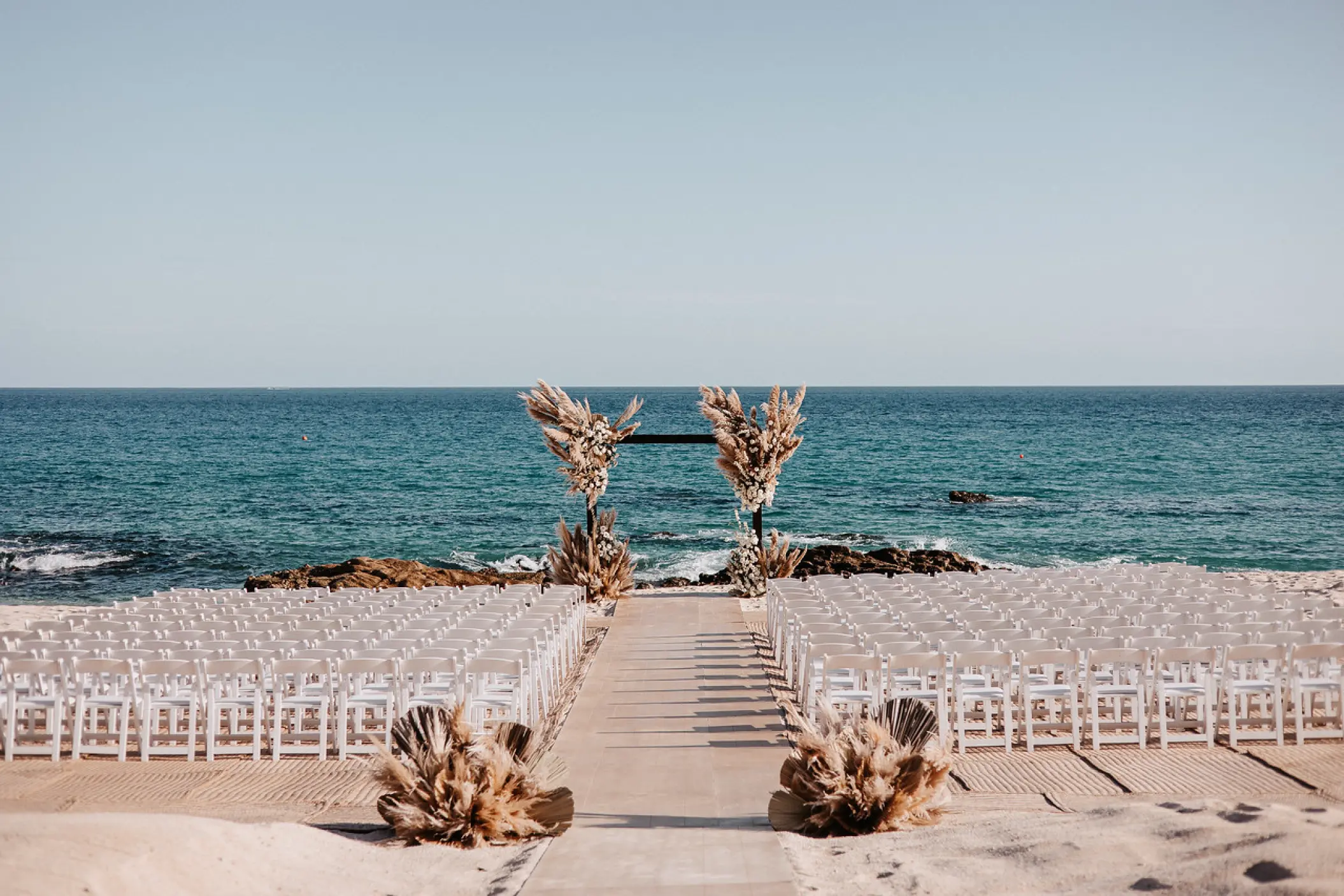 Beachfront wedding ceremony setup at Hilton Los Cabos, Cabo San Lucas